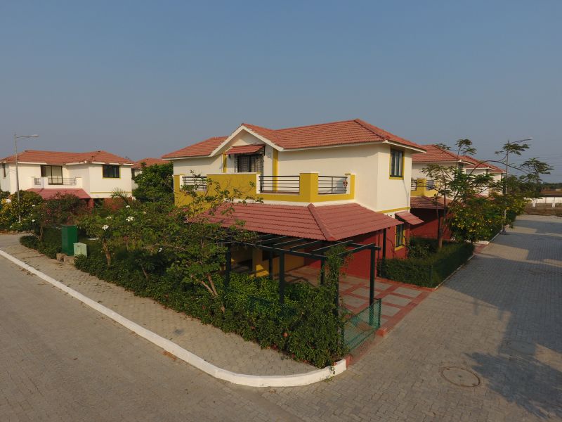 The car porch and front garden of a villa